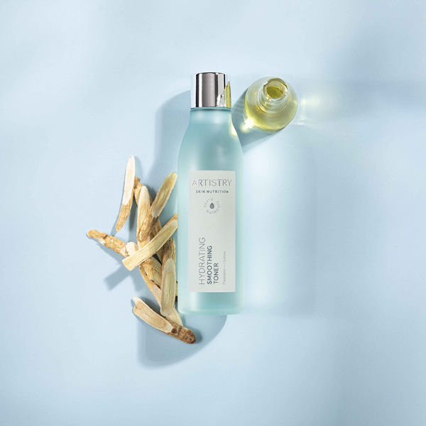 Hydrating Smoothing Toner with Ingredients on Blue Background Artistry Skin Nutrition Stylized Product and Ingredient Photography