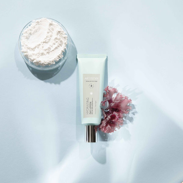 Hydrating Day Lotion with Ingredients on Blue Background Artistry Skin Nutrition Stylized Product and Ingredient Photography